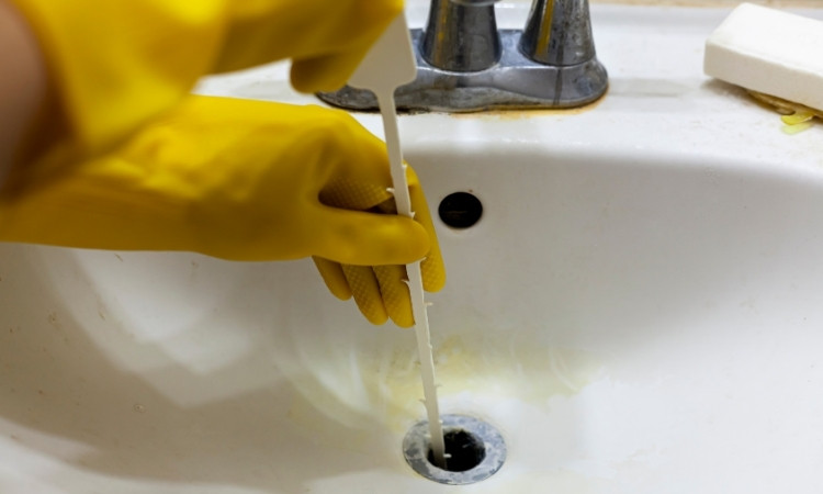 clean a bathroom sink drain